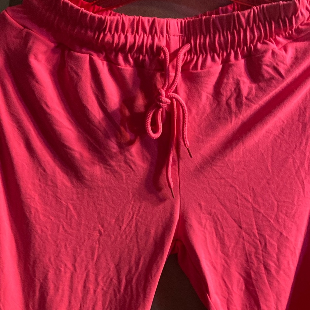 A pink jogger pants with drawstrings. It’s small